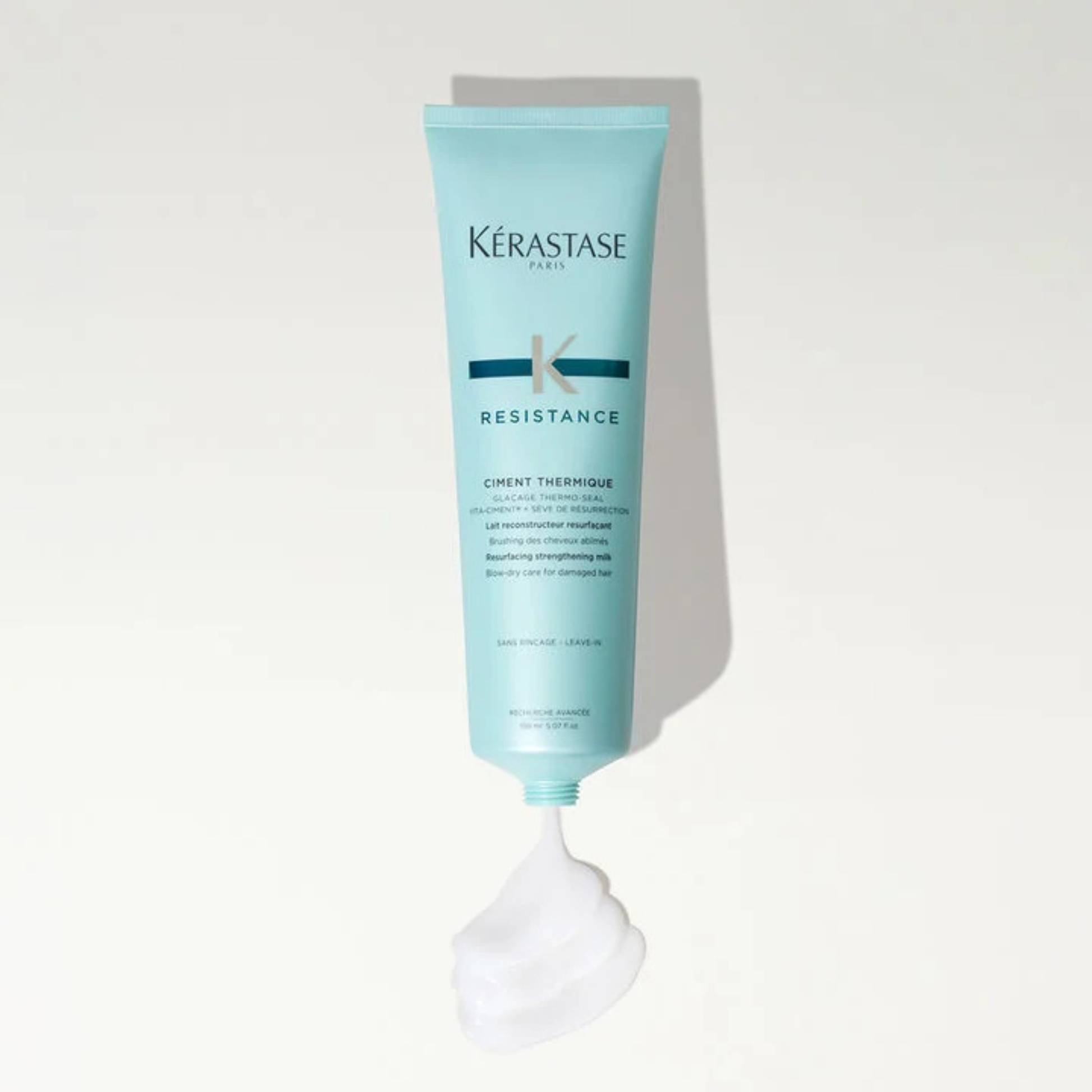 Applying Kérastase Ciment Thermique Heat Protecting Cream to strengthen and protect hair from heat styling — Bauhaus Salon + Spa Lake Charles